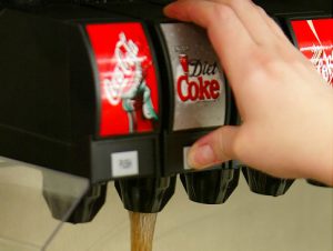 PEMBROKE PINES, FL - JULY 18: A Diet Coke is poured on a Big Gulp cup at a 7-Eleven store on July 18, 2002 in Pembroke Pines, Florida. The Big Gulp Car Cup is 32-ounces of cool fountain refreshment that fits in the cup holder of most vehicles. 7-Eleven, Inc., the premiere name and largest chain in the convenience retailing industry, is observing its 75th anniversary in 2002. (Photo by Joe Raedle/Getty Images) Original Filename: 1133934.jpg